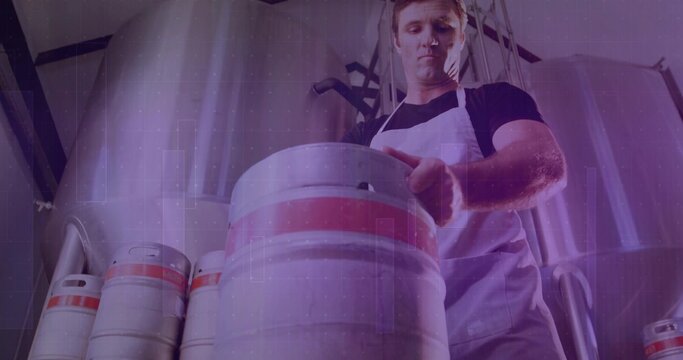 Brewery worker wearing white apron lifting keg on brewery floor, with fermentation tanks, pipes - Powered by Adobe