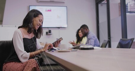 Smiling early career worker using tablet in conference room, with coffee cup, screen, copy space