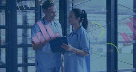 Analyzing chart and graph on tablet, doctors working in corridor with metal frame and stethoscopes