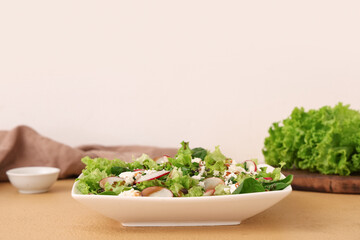 Plate of tasty salad with cheese on color table