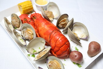 Seafood Boil Dish with Lobster, Clams, Mussels, Shrimp and Corn on Plate