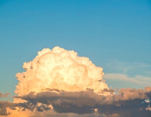 Fluffy cumulus cloud against a pale blue sunset sky