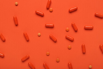 Different pills on orange background