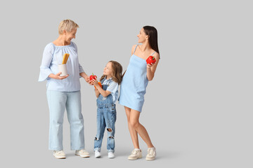 Fototapeta premium Happy family with pasta and bell peppers on light background