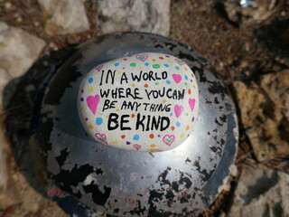Be kind kindness rock on old circular metal dome