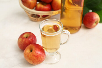 Glass cup of fresh apple cider and fruits on white background