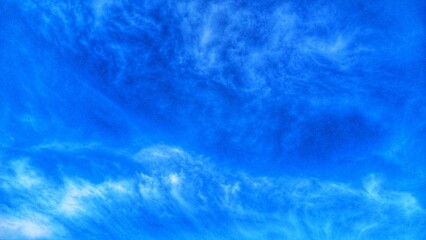 Deep blue sky with dramatic and textured white clouds.