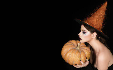 Halloween sexy woman portrait. Halloween sensual girl in witch hat. Halloween pretty woman face...