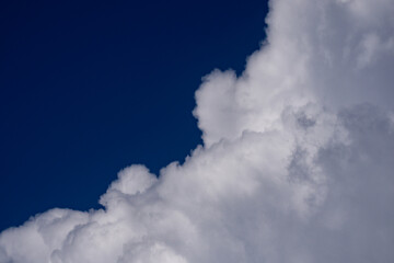 Obraz premium Background with cloudy skies. Cumulus clouds in sky. Cloud wallpaper. Sky background. Cloudy sky with sunlight. White clouds wallpaper. Blue sky and white clouds background. Idyllic cloud.
