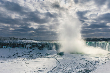 A stunning winter view of Niagara Falls,  Canadian Horseshoe Falls, dramatci winter landscape at Niagara Falls, Ontario, Canada