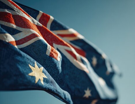 Close-up of waving Australian flag against clear sky - Powered by Adobe