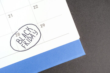 Inscription Black Friday on calendar 2025 close-up on black background.