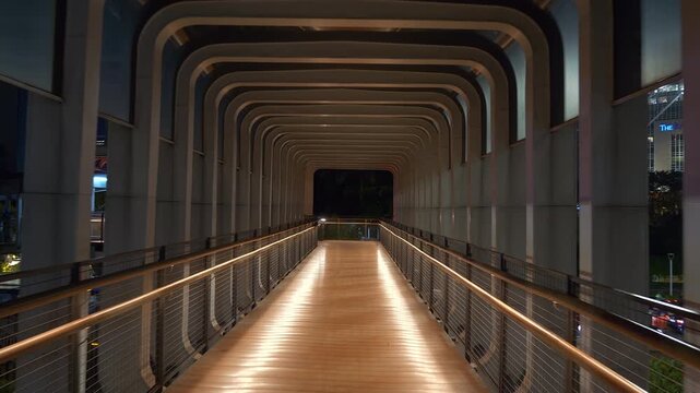 night time illumination jakarta city downtown famous pedestrian crosswalk bridge walking pov panorama 4k indonesia
