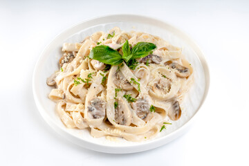 Pasta carbonara cream sauce with mushroom in a white plate