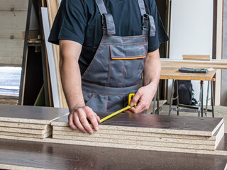 Preparing Wood Panels for Cutting with Selective Focus on the Tape Measure