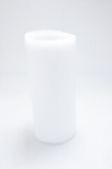 Soft Roll of White Foam Material Isolated on a Neutral Background