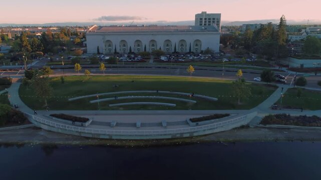 Aerial view of Lake Merritt in Oakland, California, USA. People are enjoying the park and lakefront. The Kaiser Convention Center is in the background.
