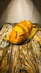 Fresh baked loaf of bread on a wooden board