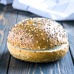 Fresh baked sesame bun on wooden table