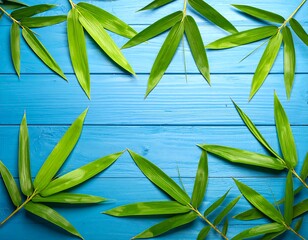 Fresh bamboo leaves on a bright blue wooden surface