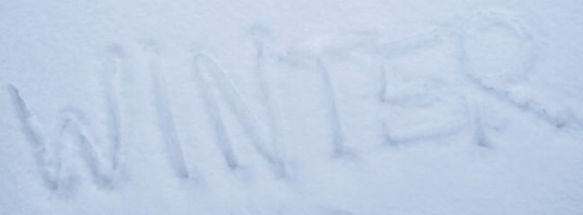Word WINTER written in the frozen snow in winter season. Concept of cold snowy weather forecast....