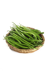 Fresh Green Chili Peppers in Wicker Basket on White Background