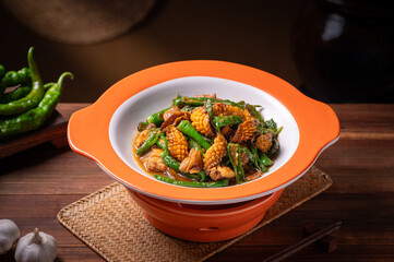 Stir-fried abalone and green pepper, old kitchen interior wooden tabletop background