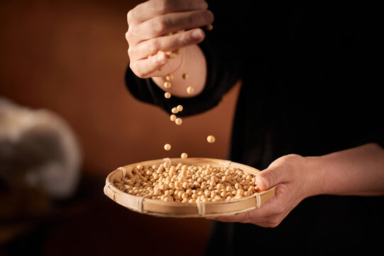 The Artisanal Process of Creating Tofu and Soy Milk by Hand,Grinding Soaked Soybeans with Stone Mill for Fresh Soy Milk