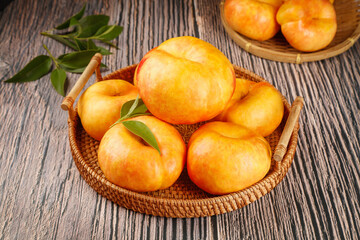 Fresh Golden Nectarines from Shandong Orchard in Wicker Baskets on Rustic Wood Table