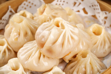 Freshly Steamed Xiao Long Bao Chinese Soup Dumplings in Traditional Bamboo Steamer Basket