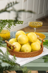 Fresh Passion Fruit in Wicker Basket with Tropical Drinks on Kitchen Table
