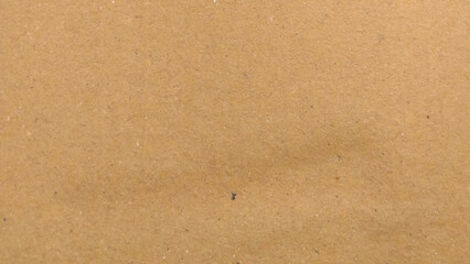 Background of brown kraft paper or cardboard texture. Abstract pattern of beige rough carton, old paper sheet, parchment or papyrus surface.