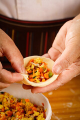 Freshly Made Dumpling with Mixed Vegetable Filling Held in Hands Ready for Steaming