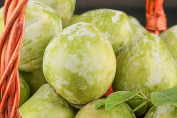 Fresh Nectarines and Plums from Fujian Gutian China in Wicker Basket at Local Market