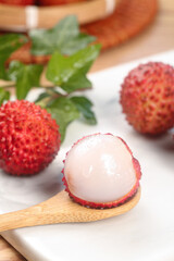 Fresh Lychee Fruit from Guangdong China Showing Sweet White Flesh and Red Skin on Wooden Spoon