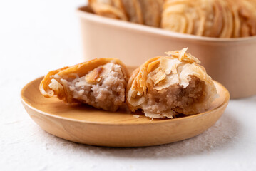 Curry puff stuffed with sweet taro on wooden plate, Thai snack food style