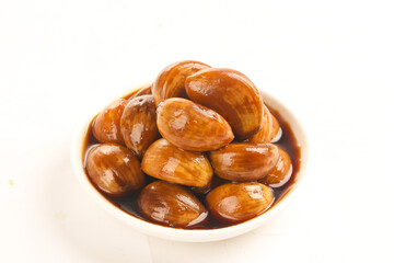 Fresh clams in garlic sauce on white background - seafood delicacy in ceramic bowl