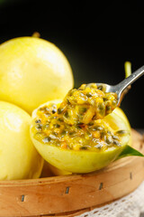 Golden Passion Fruit from Hainan China Showing Fresh Pulp and Seeds on Wooden Basket