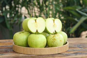 Freshly Picked Sweet and Tart Green Apples from Shandong China on Wooden Tray