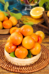 Fresh Xinjiang Apricots in Woven Basket - Organic Summer Fruit Display on Rustic Wooden Table