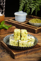 Traditional Green Tea Matcha Sachima Chinese Sweet Dessert on Rustic Wood Tray Kitchen Setting