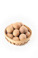 Dried Longan Fruits in Bamboo Basket on White Background - Traditional Asian Tropical Delicacy