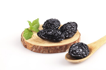 Xinjiang Air-Dried Prunes on Wood Slice with Mint - Healthy Organic Dried Fruit on White Background