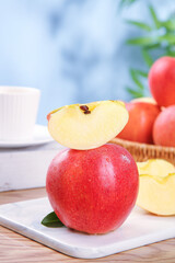Fresh Red Fuji Apples Sliced on White Cutting Board with Shallow Depth of Field