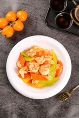 Fried Shrimp Stir-Fry with Bell Peppers and Vegetables on White Plate - Asian Seafood Dish