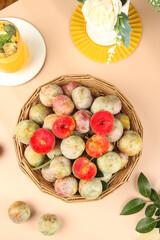 Fresh Red Plums in Wicker Basket - Organic Stone Fruit Display with Cut Halves Showing Juicy Interior