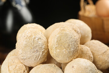 Raw Potatoes with Golden Flour Coating in Rustic Kitchen Setting
