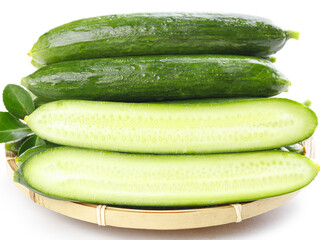 Fresh Green Cucumbers Whole and Sliced on Bamboo Tray with Water Droplets