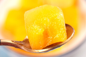 Traditional Golden Crystal Candy Confection on Wooden Spoon - Asian Sweet Preserve