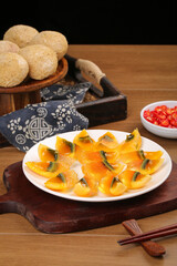 Chinese Salted Duck Egg Yolks with Golden Centers and Traditional Steamed Buns on Wooden Table